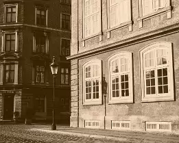 Vintage Streetscape Sepia street scene on Ny Vestergade with a vintage lamp casting shadow against brick facades in Copenhagen.