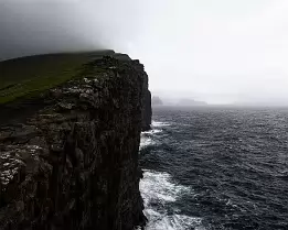 Rugged Majesty Steep cliff face at Trælanípa rising above the Atlantic Ocean in the Faroe Islands.