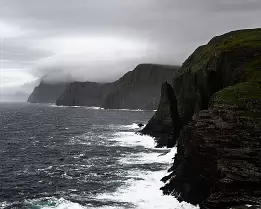 Distant Fade Jagged cliffs fading into the mist in the Faroe Islands near Trælanípa.