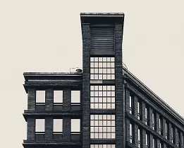 Triangular Landmark Black and white photo of the triangular red brick K13 building on Kaisaniemenkatu in Helsinki.
