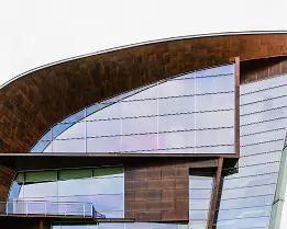 Curved Art Kiasma Museum of Contemporary Art in Helsinki with curved glass façade and sculptural roof.