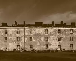 Weathered Walls Old weathered building with peeling plaster and rows of windows on Länsi-Mustasaari Island in the Suomenlinna district of Helsinki.