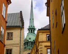 Spire Peek The slender green spire of the German Church (Tyska Kyrkan) rises above tight, pastel alleyways in Gamla Stan.