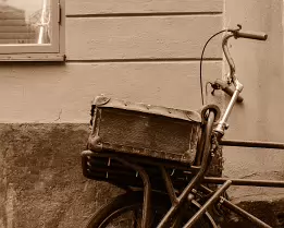 Rustic Wheel A weathered cargo bicycle rests against a stucco wall on a cobblestone lane in Stockholm’s Old Town.